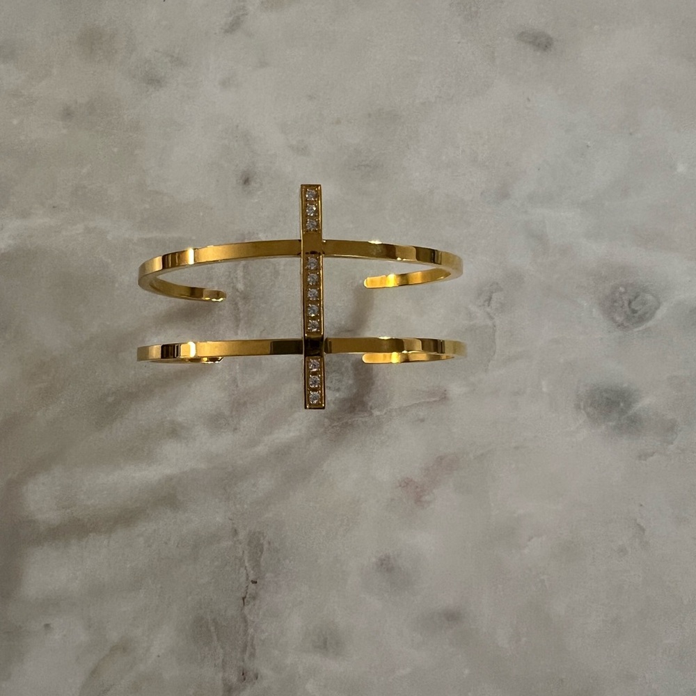 Modern, gold tone cuff bracelet.